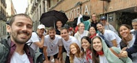 a group of people posing for a photo in a city